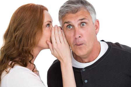 Woman telling secret to her partner on white background