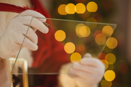 Close up of santa writing list on the glass at home in the living roomの写真素材