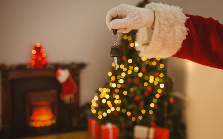 Hand of santa holding car key at home in the living roomの写真素材