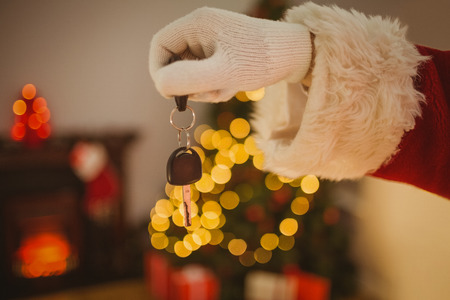 Hand of father christmas holding car key at home in the living roomの写真素材