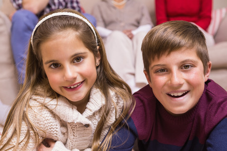 Portrait of smiling brother and sister at home in the living roomの写真素材