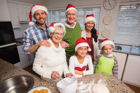Multi-generation family baking together at home in the kitchen