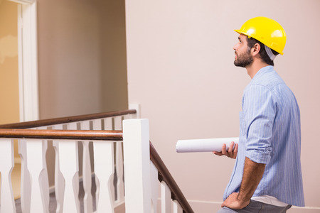 Casual architect walking up the stairs in a new house