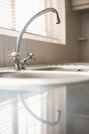 Brushed steel sink in the kitchenの写真素材