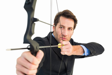 Close up of businessman shooting bow and arrow on white backgroundの写真素材