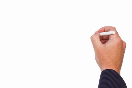 Hand of a businessman writing with a chalk on white backgroundの写真素材