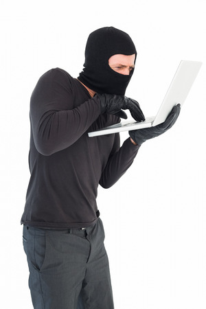 Hacker using laptop to steal identity on white backgroundの写真素材