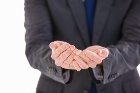 Handsome businessman presenting with hands on white background