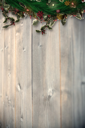 Festive christmas wreath with decorations against bleached wooden planks backgroundの写真素材