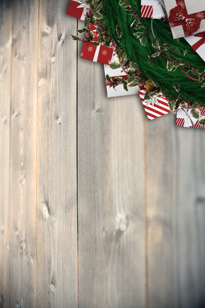 Festive christmas wreath with decorations against bleached wooden planks backgroundの写真素材