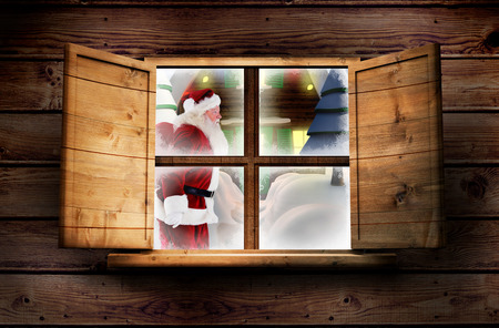 Santa delivery presents to village against window in wooden roomの写真素材