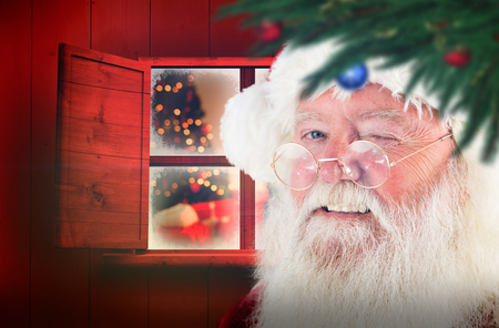 Santa claus winking against christmas at homeの写真素材