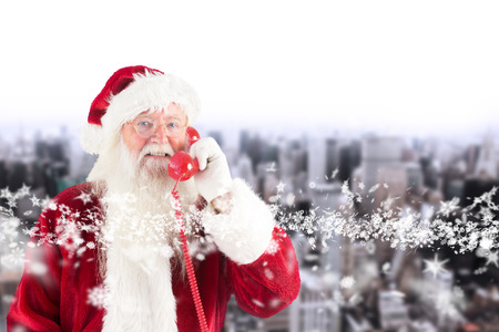 Santa claus on the phone against high angle view of cityの写真素材