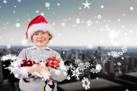 Festive boy smiling against high angle view of city skylineの写真素材