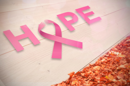 Breast cancer awareness message against autumn leaves against white woodの写真素材