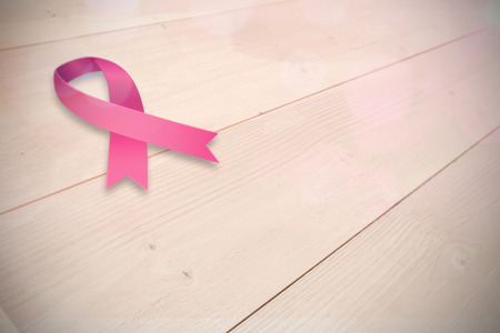 Breast cancer awareness ribbon against bleached wooden planks backgroundの写真素材