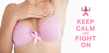 Woman in bra with breast cancer awareness ribbon against breast cancer awareness messageの写真素材