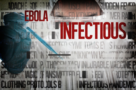 Protected female scientist dropping a blue liquid in a test tube against ebola words