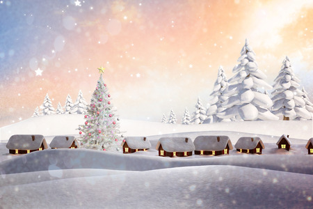 Snow covered village against snowy landscape with fir treesの写真素材