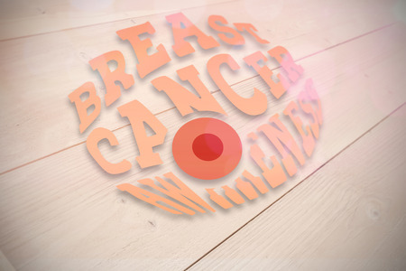 Breast cancer awareness graphic against bleached wooden planks background