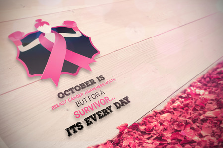 Breast cancer awareness message against autumn leaves against white woodの写真素材