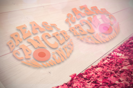 Breast cancer awareness graphic against autumn leaves against white woodの写真素材
