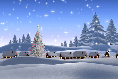 Snow covered village against snowy landscape with fir treesの写真素材