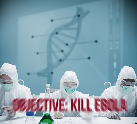 Chemists working in protective suit with futuristic interface showing DNA diagram behind themの写真素材