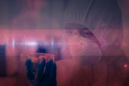 Scientist in protective suit analyzing pills against ecg line in red and black