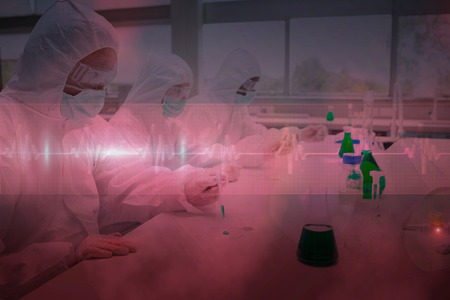 Three chemists working in protective suits against ecg line in red and blackの写真素材