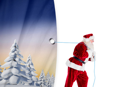 Santa claus pulling rope against white curtain blindの写真素材