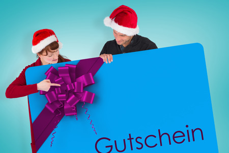 Couple holding a white sign against blue vignetteの写真素材