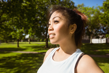 Healthy and beautiful young woman looking away in park