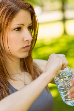 Pretty redhead determined on her health in parkの写真素材
