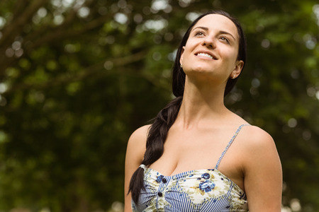 Portrait of a brunette enjoying the sunshine in the parkの写真素材