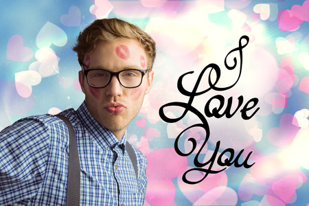 Geeky hipster covered in kisses against valentines heart designの写真素材