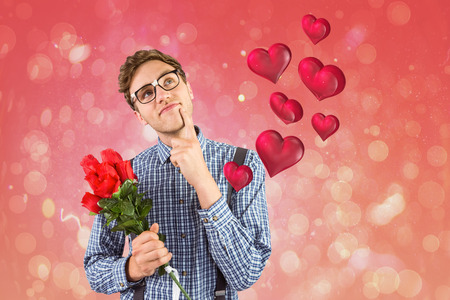 Geeky hipster holding a bunch of roses against red abstract light spot designの写真素材