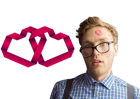 Geeky hipster covered in kisses against linking heartsの写真素材
