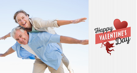 Happy casual couple having fun against happy valentines dayの写真素材