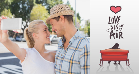 Young hip couple taking a selfie against love is in the airの写真素材