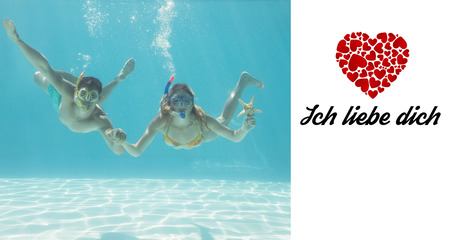 Cute couple underwater in the swimming pool with snorkel and starfish against ich liebe dichの写真素材