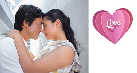Happy couple hugging each other against love heartの写真素材