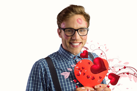 Geeky hipster covered in kisses against valentines heart designの写真素材