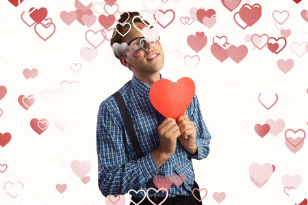 Geeky hipster covered in kisses against valentines heart designの写真素材