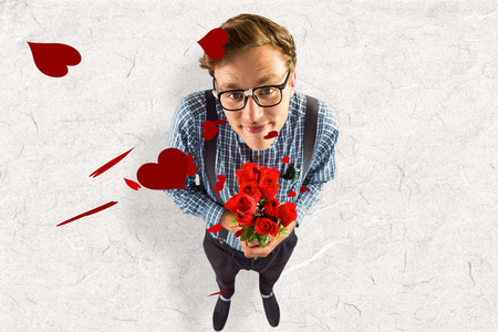 Geeky hipster holding a bunch of roses against parchmentの写真素材
