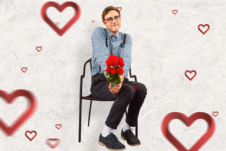 Geeky hipster holding a bunch of roses against parchmentの写真素材