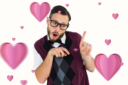 Geeky hipster in sweater vest pointing  against heartsの写真素材