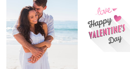 Affectionate couple cuddling against cute valentines messageの写真素材