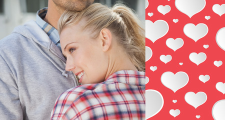 Hip young couple hugging each other against heart patternの写真素材