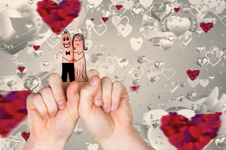 Fingers crossed like a couple against love heart patternの写真素材